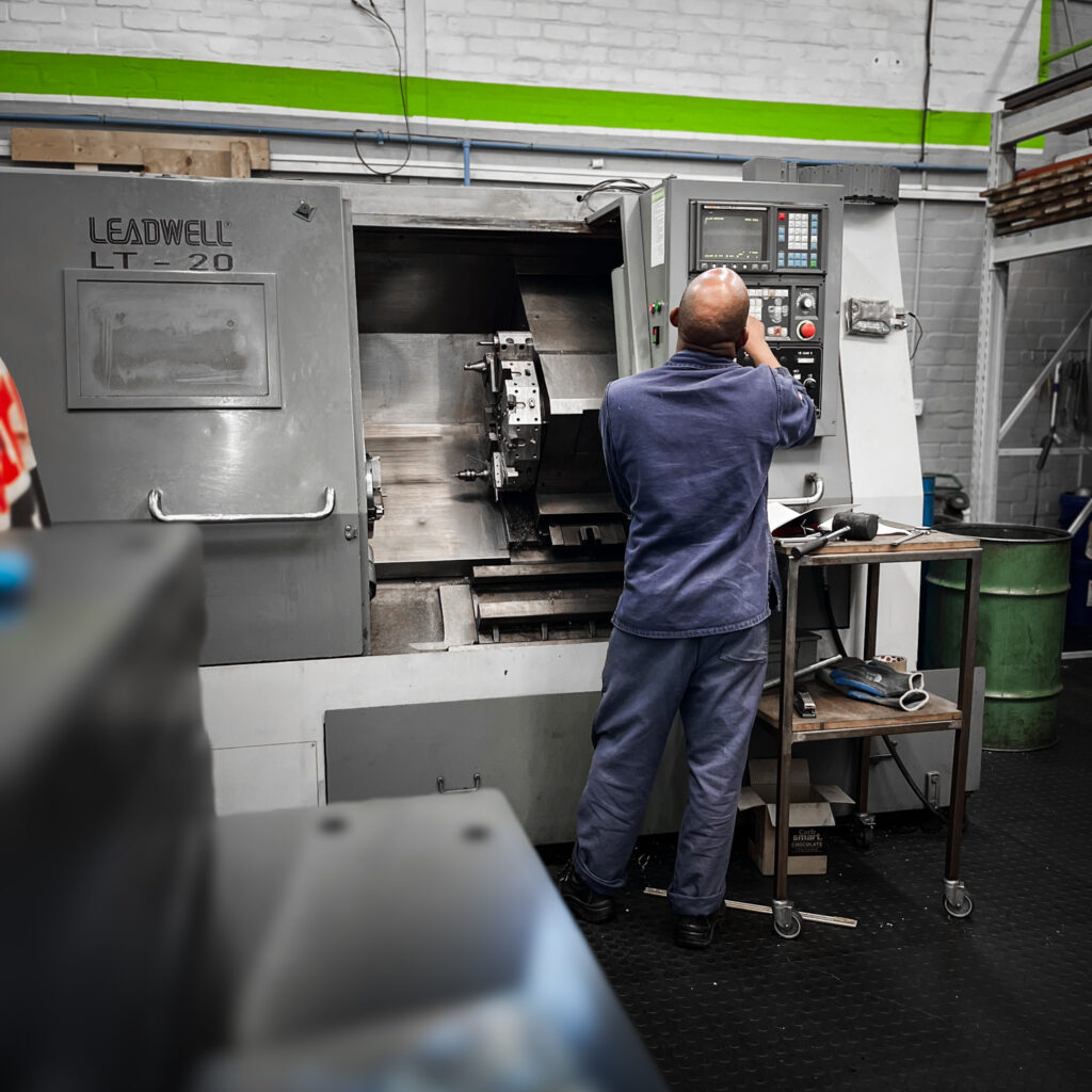 Qualified fit and turner engineer machining custom parts for Cape Town customers on a large CNC machine
